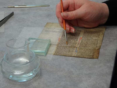 A torn piece of parchment is treated with isinglass