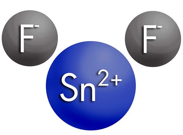 A molecular diagram of a Sn2+ ion (represented by a blue circle) and two F- ions (represented by grey circles)
