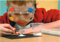 Boy wearing goggles looking at an experiment