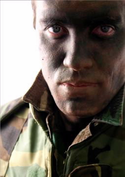 soldier in camouflage makeup