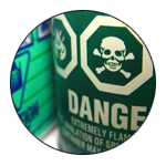 Chemical warning on a green bottle.