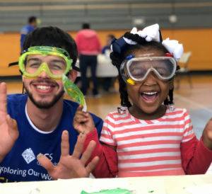 ACS volunteer and young girl smile at Kids Zone event in New Orleans
