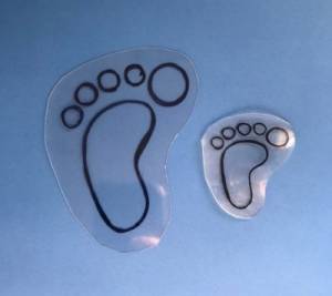 Two pieces of plastic in the shape of a footprint: one before heating and one after