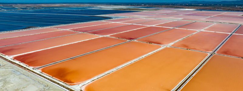 Aerial view overlooking red and blue salt production