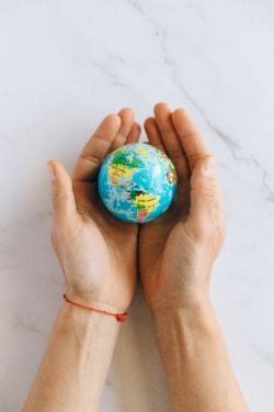 hands holding mini-globe