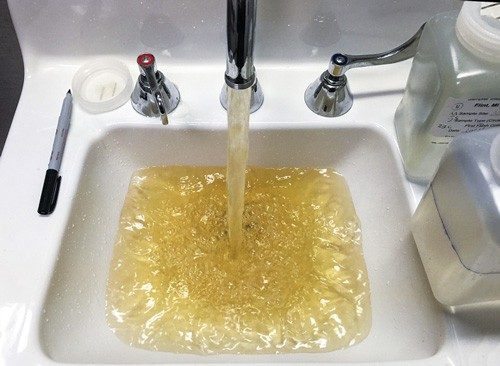 Brown/yellow water flowing from a faucet