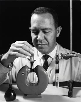Photo of  Stephen Papell demonstrating effects of a magnetic field