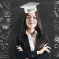 Person with graduation cap standing in front of chalkboard