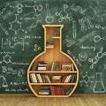 Bookcase in share of a flask in front of a chalkboard covered with chemistry and science related graphics