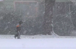 A child walks down a snowy street