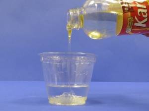 Pouring corn syrup into water