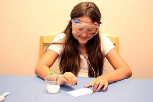 Using cotton swab to write on card with baking soda solution 