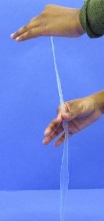 Pulling plastic strip between fingers.