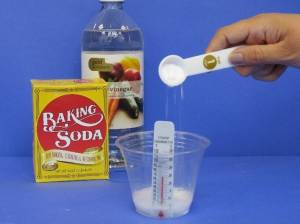 Putting baking soda into vinegar.