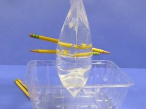 Two pencils through a plastic bag of water.