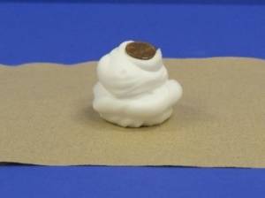 Shaving cream with penny on top.
