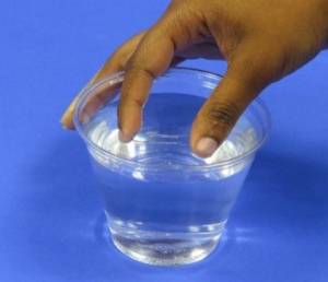fingers putting paper clip on water