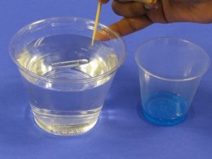 toothpick and detergent at water surface