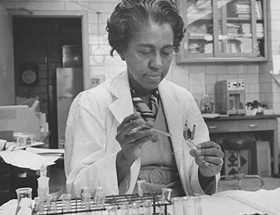 Black and white photograph of Daly working in the lab
