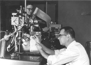 Fred McLafferty and Roland Gohlke (in foreground) work on a Bendix mass spectrometer at Dow circa 1960. 