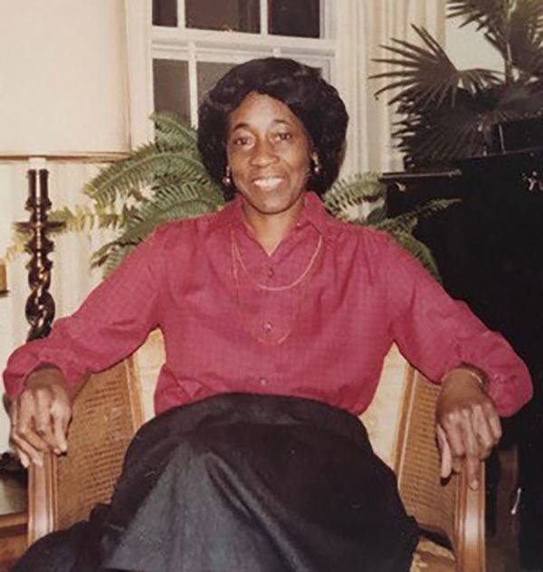 Bettye Washington Greene sitting in a chair and smiling at the camera