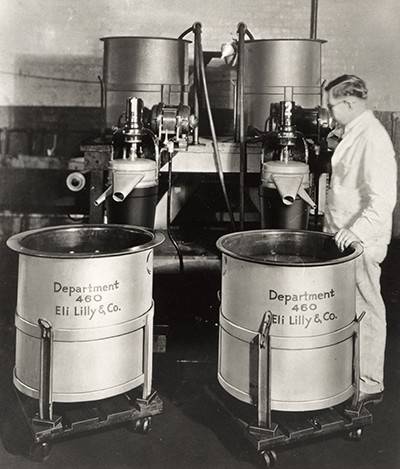 Black and white photo of an operator and two centrifuges