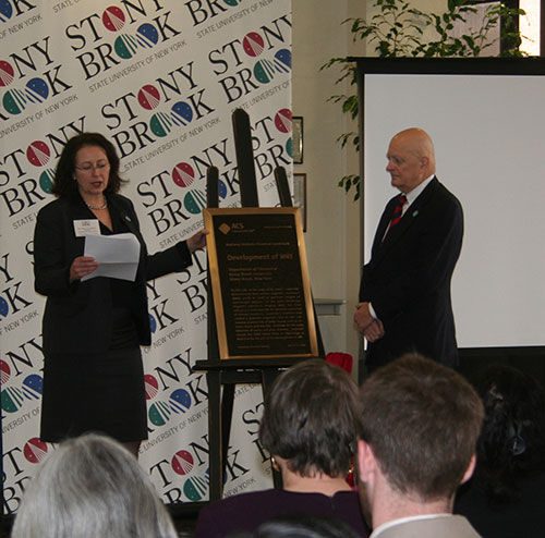 ACS President Nancy B. Jackson presents the NHCL plaque