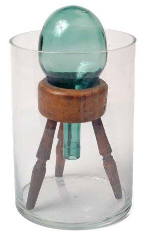 An inverted round bottom flask on a wooden stand inside another glass cylindrical flask
