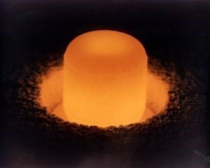 A pellet of plutonium-238 oxide glows with heat generated by its radioactive decay.