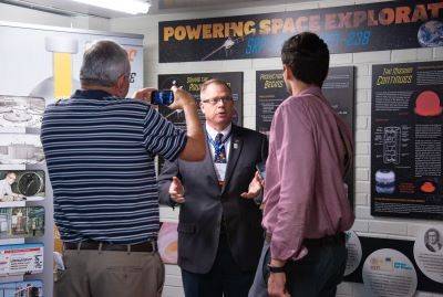 ACS President Peter Dorhout is interviewed by local media during the Landmark designation ceremony while standing in front of an exhibit about the achievement.
