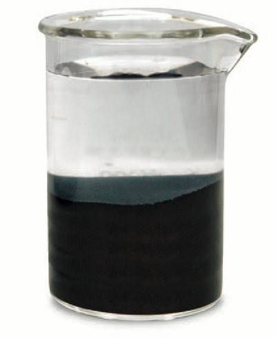 A beaker contains Raney nickel under water