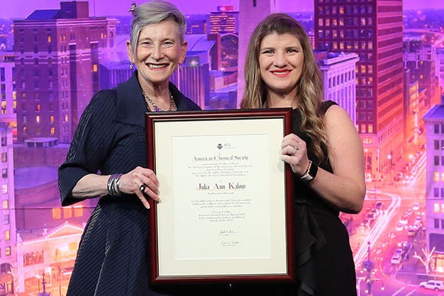 Danna E. Freedman, 2019 recipient, smiles on stage while receiving her ACS award.