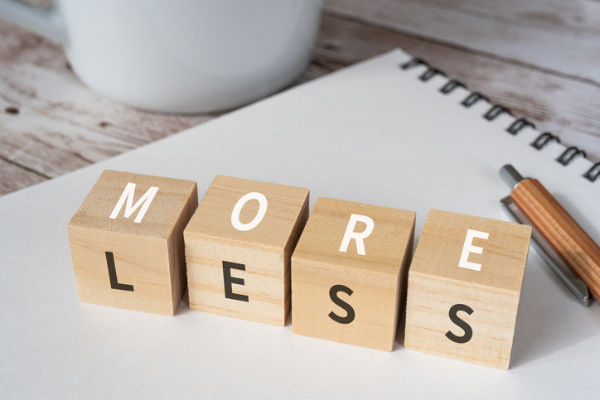 Blocks spelling out the words "more" and "less"