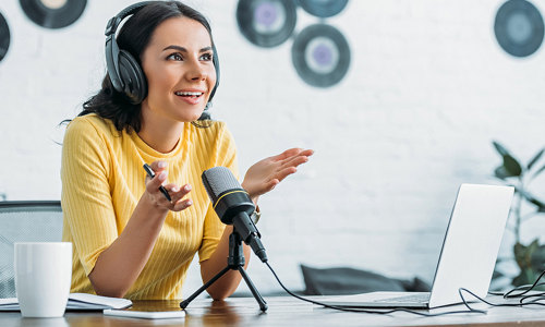 Woman speaking into a podcast