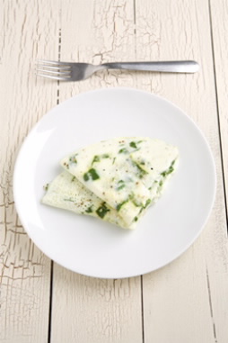 Spinach egg white omelet on white plate