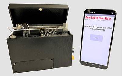 A portable device for analyzing saliva samples and a smartphone with text reading "GuanLab @ PennState SARS-CoV-2 Detection with LAMP in a Mobile Device" and a gray button reading next.