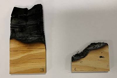 Two pieces of firewood: on the left, coated wood with less burn damage; on the right, bare wood with more fire damage