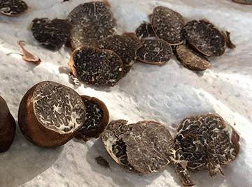 Several Appalachian truffles half sliced into slivers