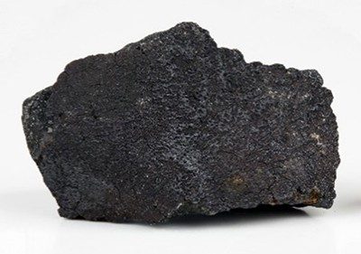 The Murchison meteorite, a black rock with a rough surface.