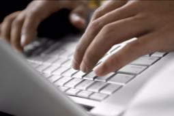 Person typing on a laptop/notebook computer keyboard