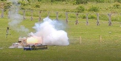 Smoke from a gunpowder test in an empty field.