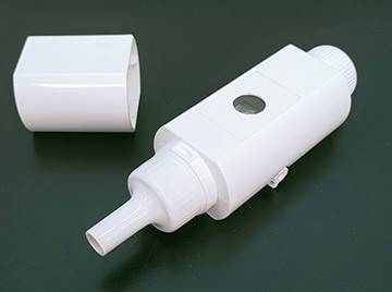 Small, white plastic breathalyzer device, with top uncapped