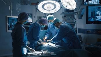 Medical professionals perform surgery in an operating room