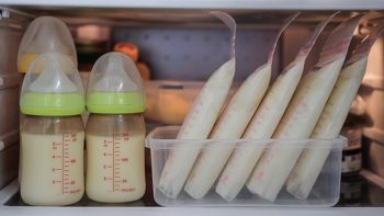 Bottles and bags of breastmilk stored in a refrigerator.