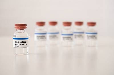 A line of glass insulin vials.