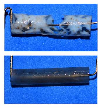 The top photo shows a short piece of a white straw with holes caused by degradation. The bottom photo shows a short piece of a dark gray straw that’s intact. 