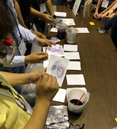 Students from Heidelberg University use grape juice to reveal writing on paper.